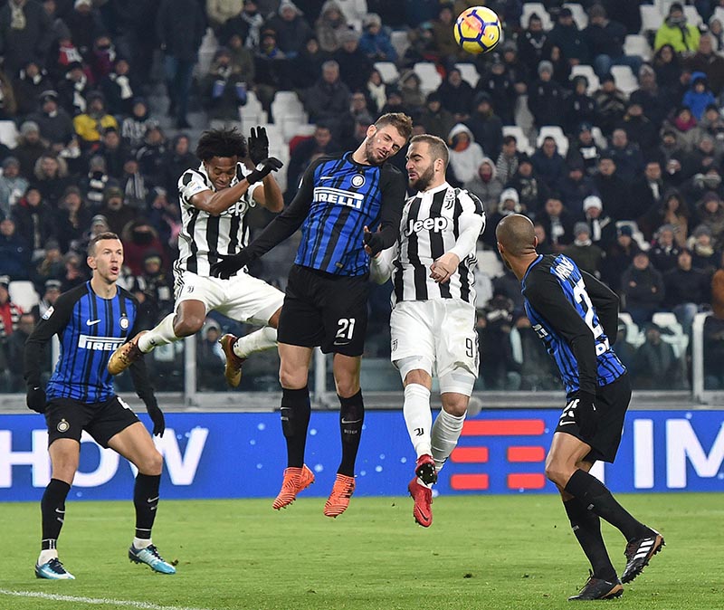 Juventus' Gonzalo Higuain (second from right), and Inter Milan's Davide Santon (centre), and Juventus' Juan Cuadrado (second from left), vie for the ball during a Serie A soccer match between Juventus and Inter Milan at the Allianz Stadium in Turin, Italy, on December 9, 2017.  Photo: Alessandro Di Marco/ANSA via AP