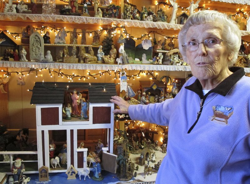 Shirley Squires, of Guilford, Vt., speaks with a reporter about her collection of more than 1,400 nativity scenes on display in her home. Each Christmas, she gets help putting up the miniature scenes and then opens her home to school groups and others for viewing, on December 20, 2017. Photo: AP