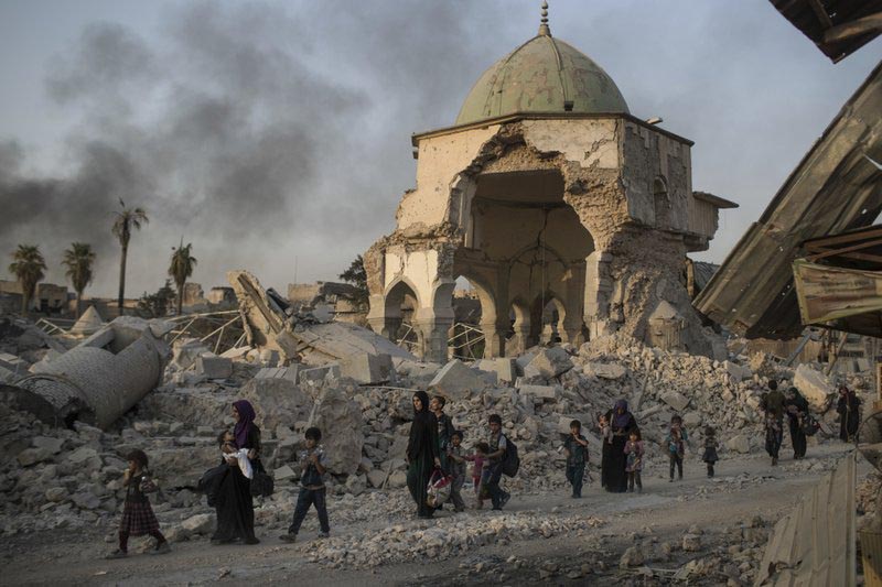 Iraqi civilians fleeing walk past the destroyed al-Nuri mosque as Iraqi forces continue their advance against Islamic State militants in the Old City of Mosul, Iraq, Tuesday, July 4, 2017.Photo: AP
