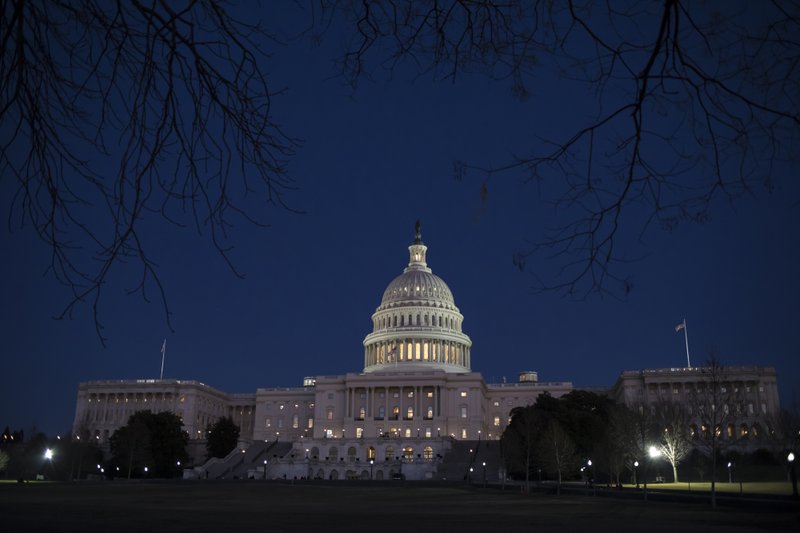 With no apparent indications of a breakthrough in the Senate to avoid a government shutdown, the Capitol is illuminated in Washington, Friday evening, Jan. 19, 2018.