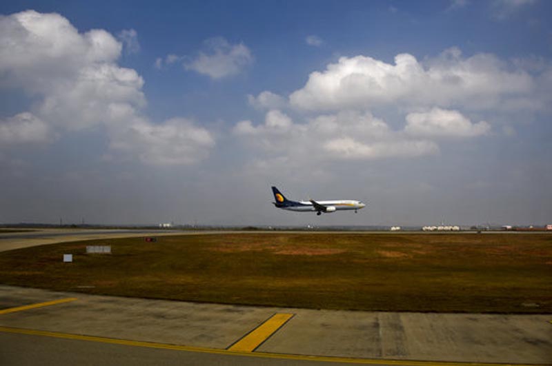 FILE- In this Dec. 25, 2017 file photo, a Jet Airways aircraft lands at the Kempegowda International Airport in Bangalore, India. India's Jet Airways says it has ordered an investigation into reports that a senior pilot slapped a female co-pilot in the cockpit during a London to Mumbai flight this week. (AP Photo/R S Iyer, File)