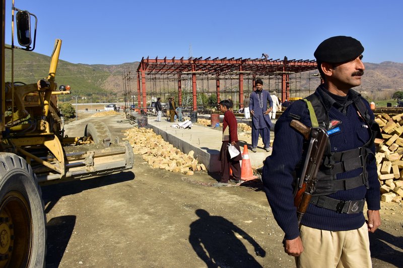 a Pakistani police officer stands guard at the site of Pakistan China Silk Road in Haripur, Pakistan. From Pakistan to Tanzania to Hungary, projects under Chinese President Xi Jinpingu2019s signature u201cBelt and Road Initiativeu201d are being canceled, renegotiated or delayed due to disputes about costs or complaints host countries get too little out of projects built by Chinese companies and financed by loans from Beijing that must be repaid.