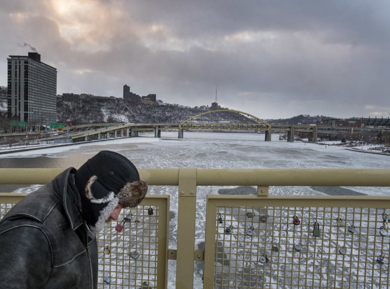 Joe McGowan of Ambridge leans into the wind as he makes his way over the Roberto Clemente Bridge on Thursday, Jan. 4, 2018, in Pittsburgh.