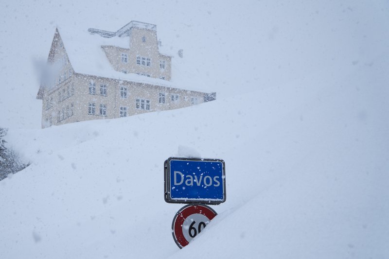 The town sign stands in the snow at the entrance to Davos, Switzerland, Monday, Jan. 22, 2018. The 48th annual meeting of the World Economic Forum, WEF, takes place in the city and brings together entrepreneurs, scientists, chief executives and political leaders from Jan. 23 to 26