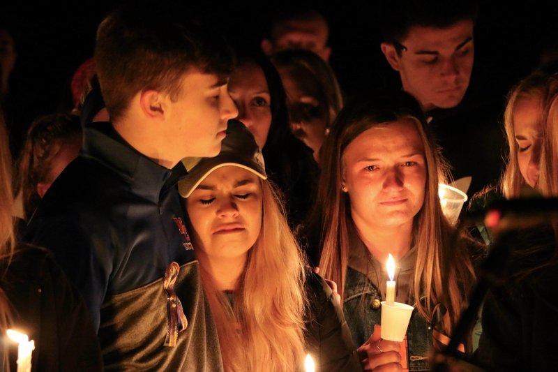 People attend a vigil for the victims of a fatal shooting at Marshall County High School on Thursday, Jan. 25, 2018, at Mike Miller County Park in Benton, Ky. The 15-year-old accused of the fatal shooting on Tuesday, which left over a dozen injured, was ordered held Thursday on preliminary charges of murder and assault