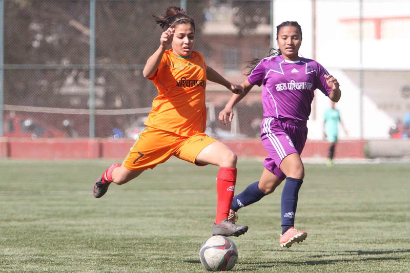 Sabina Bhattarai (left) of Western region dribbles the ball against Tika Bohara of Mid-western region during the National Women's Football League at the ANFA Complex, Satdobato, Lalitpur on Friday. Photo: Udipt Singh Chhetry