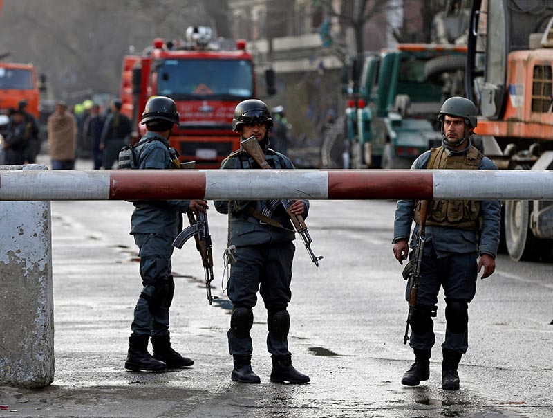 Afghan police keep watch at the site of a car bomb attack in Kabul, Afghanistan, on January 27, 2018. Photo: Reuters