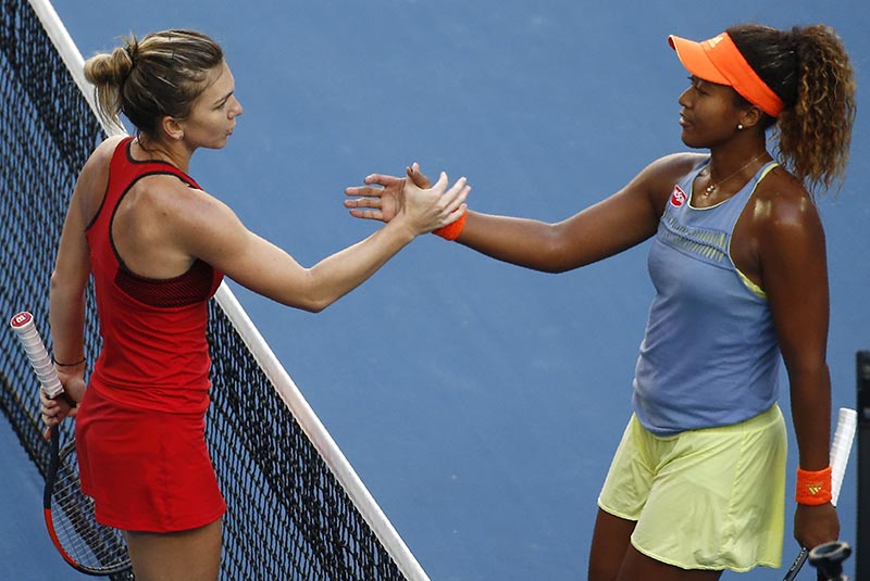 Simona Halep of Romania shakes hands with Naomi Osaka of Japan after Halep won their Australian Open match, at Margaret Court Arena, in Melbourne, Australia, on January 22, 2018. Photo: Reuters