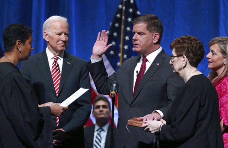 Massachusetts Supreme Judicial Court Associate Justice Kimberly S. Budd, left, administers the oath of office for Boston Mayor Marty Walsh, third from right, as former Vice President Joe Biden, second from left, and others look on during his inauguration at the Cutler Majestic Theatre, Monday, January 1, 2018. Photo: AP 