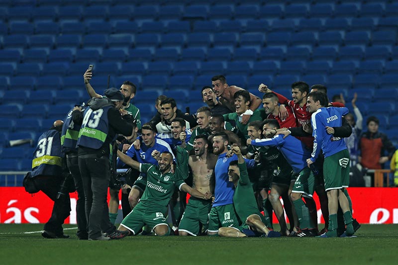Leganes' players celebrate their victory against Real Madrid at the end of the Spanish Copa del Rey quarterfinal second leg soccer match between Real Madrid and Leganes at the Santiago Bernabeu stadium in Madrid, on Wednesday, January 24, 2018. Photo: AP