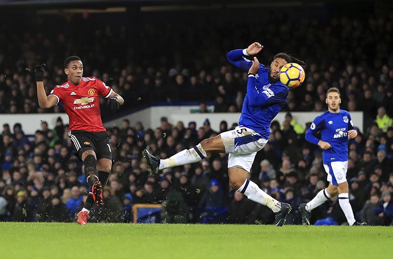 Manchester United's Anthony Martial (left), scores his side's first goal of the game, during the English Premier League soccer match between Everton and Manchester United, at Goodison Park, in Liverpool, England, on Monday, January 1, 2018. Photo: Peter Byrne/PA via AP