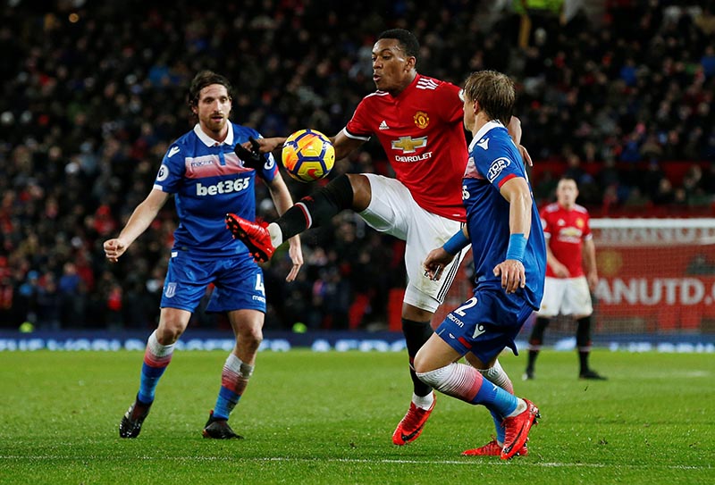 Manchester United's Anthony Martial in action with Stoke Cityu2019s Moritz Bauer and Joe Allen during the Premier League match between Manchester United and Stoke City, at Old Trafford, in Manchester, Britain, on January 15, 2018. Photo: Reuters