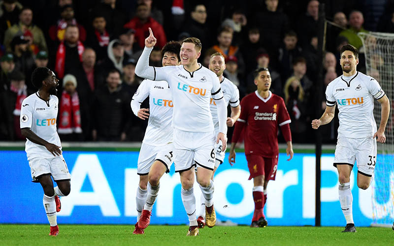 Swansea City's Alfie Mawson celebrates scoring their first goal during the Premier League Match between Swansea City and Liverpool, at Liberty Stadium, in Swansea, Britain, on January 22, 2018. Photo: Reuters