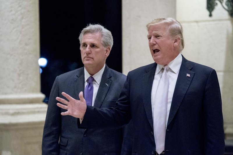 President Donald Trump, right, accompanied by House Majority Leader Kevin McCarthy, R-Calif., speaks to members of the media as they arrive for a dinner at Trump International Golf Club in West Palm Beach,on Sunday, January 14, 2018. Photo: AP