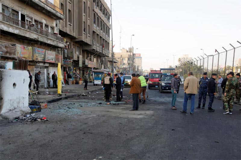 Iraqi security forces inspect the site of a bomb attack in Baghdad, Iraq, on January 15, 2018.
