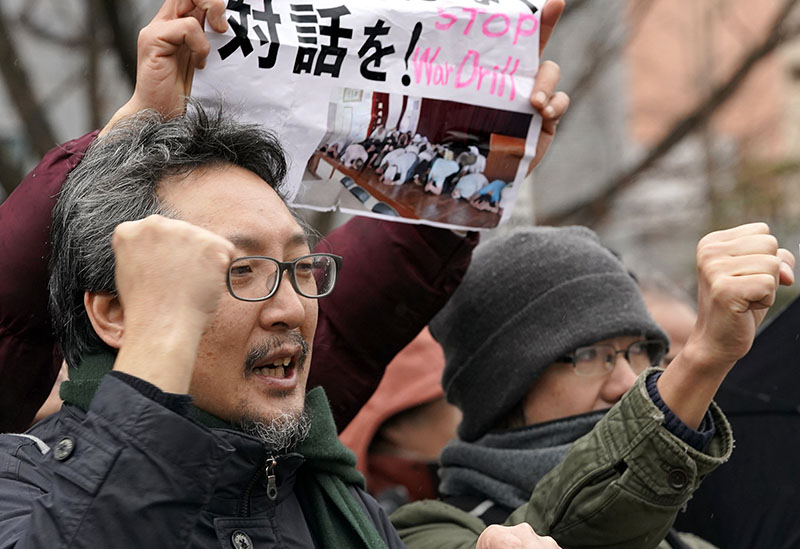 Protesters shout slogans outside the venue of an evacuation drill simulating a North Korea ballistic missile attack in Tokyo, Monday, Jan. 22, 2018. (Photo: AP)