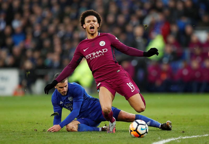 Manchester City's Leroy Sane is fouled by Cardiff City's Joe Bennett. Photo: Reuters