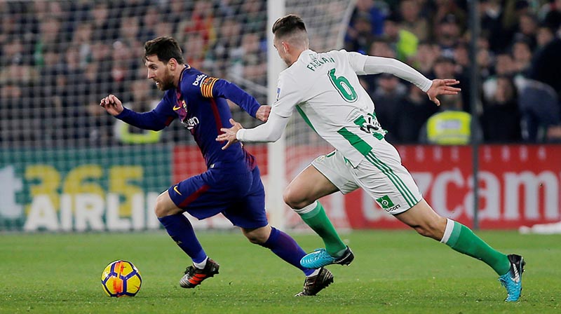 Barcelonau2019s Lionel Messi in action with Real Betis' Fabian. Photo: Reuters