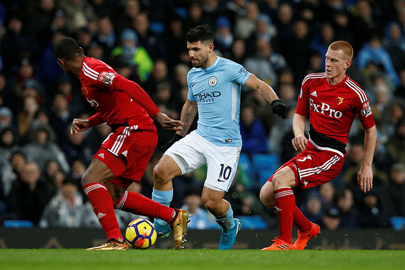 Manchester City's Aguero in action with Watford's Ben Watson. Photo: Reuters