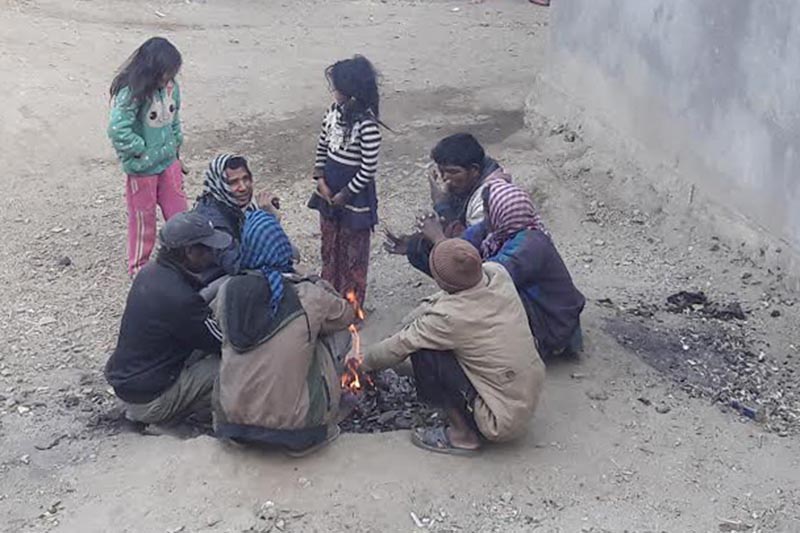 Locals warming themselves around a fire  in Martadi, Bajura, on Monday, January 8, 2018. Photo: THT