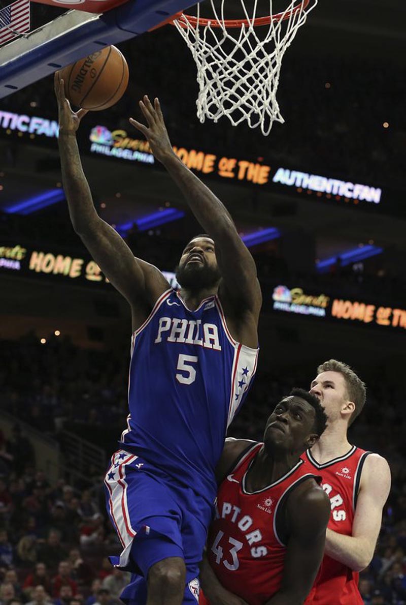 Philadelphia 76ers forward Amir Johnson (5) attempts a shot in front of Toronto Raptors forward Pascal Siakam (43) during the third quarter of an NBA basketball game in Philadelphia, Monday, Jan. 15, 2018. The 76ers won 117-111.