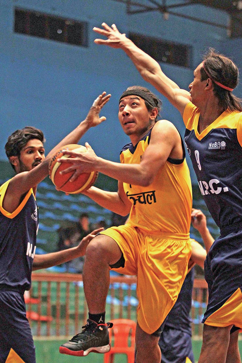 Easter Regionu2019s Manish Tamang (centre) in action against NPC during the National Basketball Championship on Wednesday. Photo: THT