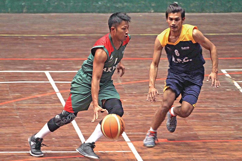 Players of TAC and NPC (right) in action during the National Basketball Championship in Kathmandu on Wednesday. Photo: THT