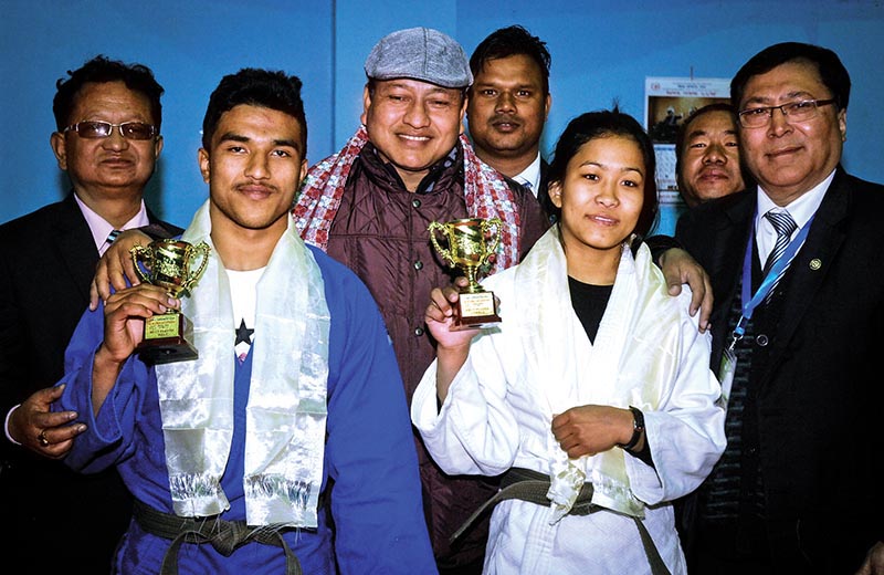 Judokas Indra Bahadur Shrestha and Manita Shrestha Pradhan hold their trophies after the 15th National Judo Tournament in Kathmandu on Sunday. Photo: THT