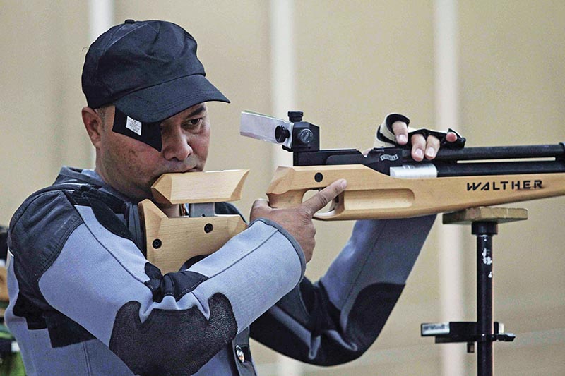 TACu2019s Krishna Ghorasaini prepares for a shot during the 10m Air Rifle event of the National Shooting Championship in Lalitpur on Thursday. Photo: THT