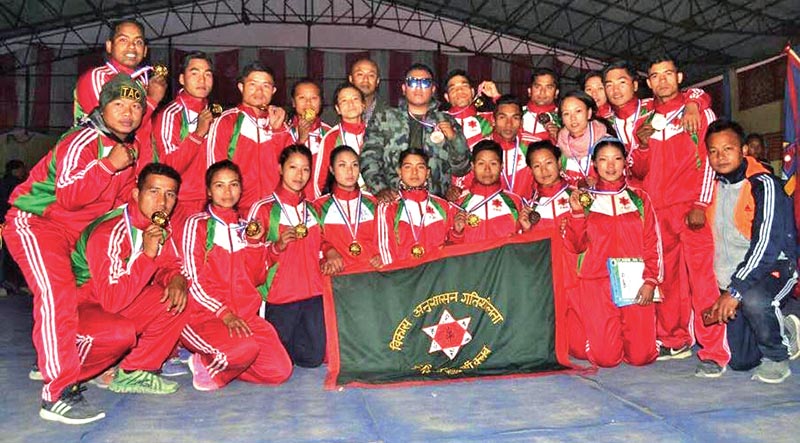 Tribhuvan Army Club team members pose for a group photo as they celebrate after winning the team championship of the National Wushu Tournament in Itahari on Monday. Photo: THT