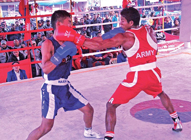 Prem Chaudhary (right) and Mingmar Gyaljen Sherpa fight during the 27th Menu2019s and eighth Womenu2019s Open Boxing Tournament in Birtamod on Wednesday. Photo: THT