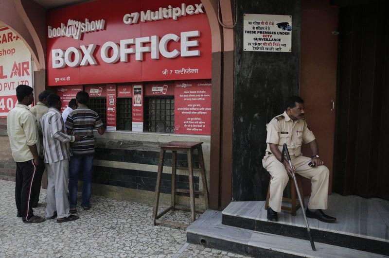 File - A policeman guards as people buy tickets at a movie theatre screening Bollywood film u0093Padmaavatu0094 in Mumbai, India, on Thursday, Jan. 25, 2018. Photo: AP