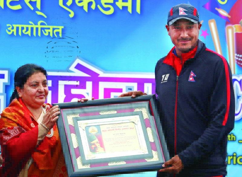 President Bidya Devi Bhandari handing over a felicitation letter to cricketer Paras Khadka at the TU Stadium in Kathmandu on Friday, Jan 19, 2018. Photo: THT