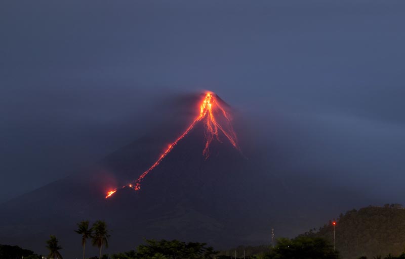 File - Lava continues to cascade down the slopes of Mayon volcano as seen from Legazpi city, Albay province, around 340 kilometers (210 miles) southeast of Manila, Philippines, at dawn on Tuesday, Jan. 16, 2018. Photo: AP