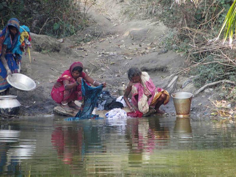 Locals cleaning utensils and washing clothes at a polluted pond, in Rajbiraj, Saptari, on Sunday, December 31, 2017. Photo: THT