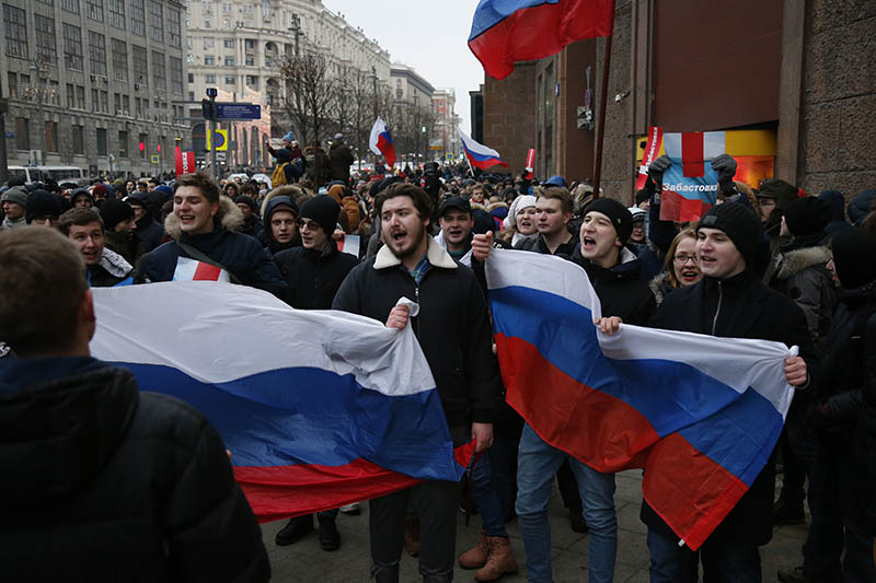Protesters with Russian flags shout slogans during a rally in Moscow to urge a boycott of Russia's March 18 presidential election, on Sunday, January 28, 2018. Photo: AP