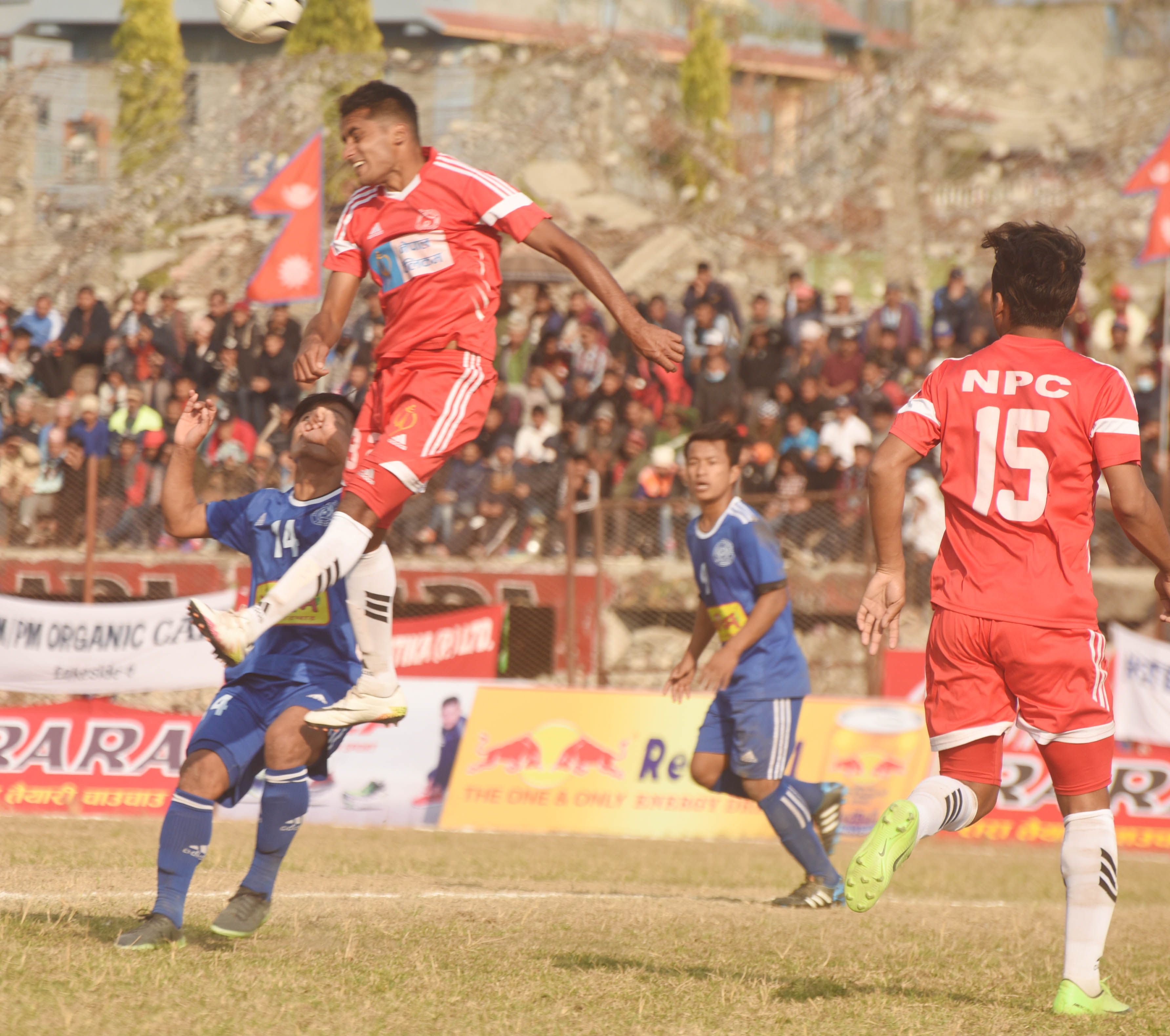 Players of Nepal Police Club (red) and Jhapa XI vying for the ball during Aaha Rara Gold Cup Football Tournament match at Pokhara Stadium, on Friday. January 26. Photo: THT 