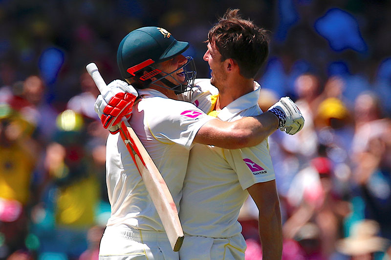 Australia's Mitchell Marsh is hugged by his brother and team mate Shaun Marsh after reaching his century during the fourth day of the fifth Ashes cricket test match. Photo: Reuters