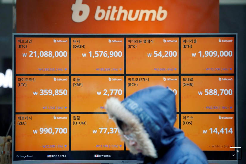 A man walks past an electric board showing exchange rates of various cryptocurrencies at Bithumb cryptocurrencies exchange in Seoul, South Korea, on January 11, 2018. Photo: Reuters/ File