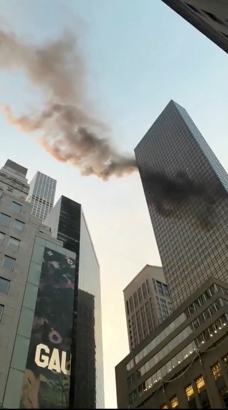 A smoke is seen rising from the roof of Trump Tower, in New York, US, January 8, 2018 in this still image obtained from social media video. Photo: Reuters