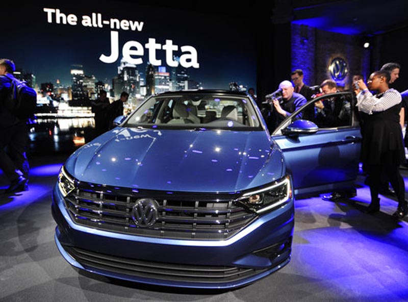Following a press conference, members of the media photograph the 2019 Volkswagen Jetta at the North American International Auto Show Sunday, Jan. 14, 2018, in Detroit. (AP Photo/Jose Juarez)