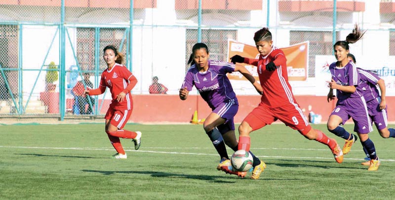 Nepal APFu2019s Sabitra Bhandari dribbles the ball past Mid-western Region players during the 16th National Womenu2019s League at the ANFA Complex grounds in Lalitpur on Monday. Photo : THT