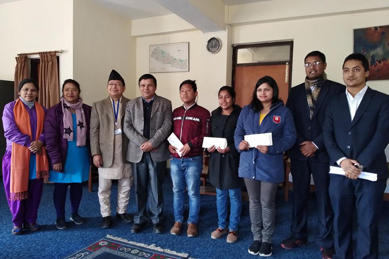 Students pose for a photograph along with the officials of Department of Information and Communications after receiving scholarship to pursue journalism, in Kathmandu, on Sunday, January 21, 2018. Photo: THT