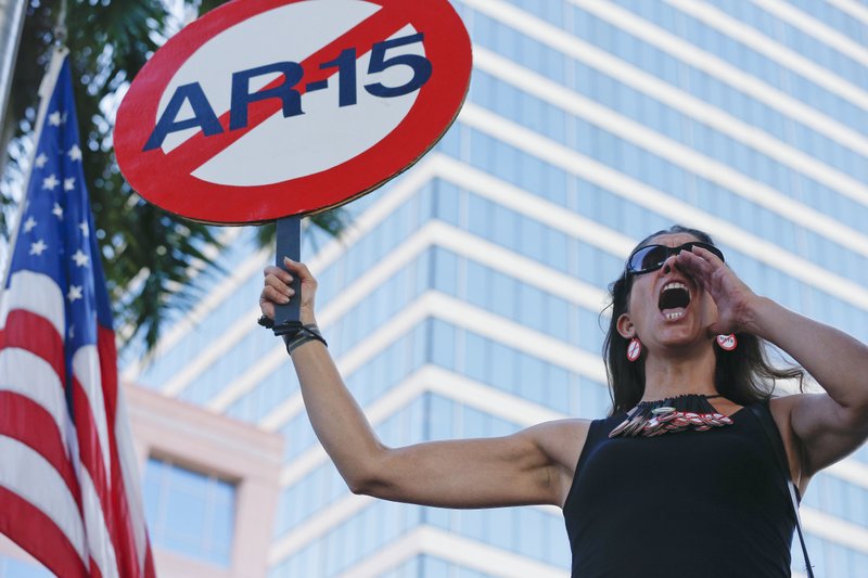 Alessandra Mondolfi holds a sign against AR-15 weapons as she yells, u201cNo Moreu201d during a protest against guns on the steps of the Broward County Federal courthouse in Fort Lauderdale, Fla., on Saturday, Feb. 17, 2018. Nikolas Cruz, a former student, is charged with killing 17 people at Marjory Stoneman Douglas High School in Parkland, Fla., on Wednesday. 
