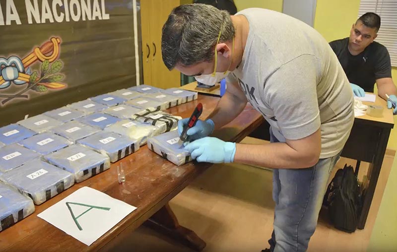 In this December 14, 2016, photo and released on February 22, 2018, by the Argentine Security Ministry, a police officer opens up a package of cocaine found in an annex building Russian embassy in Buenos Aires, Argentina. Photo: Argentine Security Minister via AP