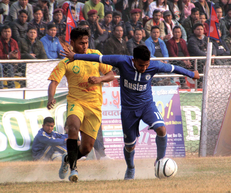 Joy Prasad of Durgapur vies for the ball with Three Staru2019s Bishal Shrestha (right) during their 20th Budha Subba Gold Cup match in Dharan. Photo: THT