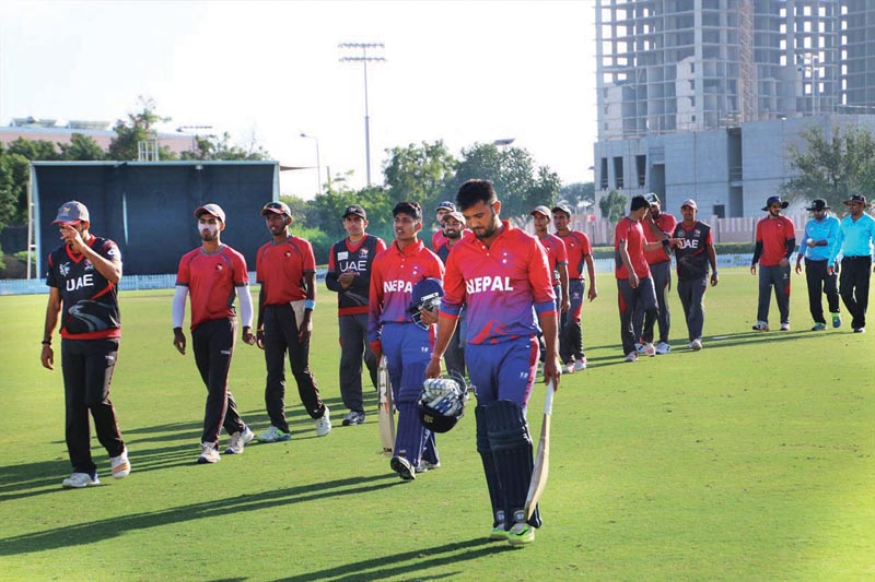 Players of Nepal and the United Arab Emirates u0091Au0092 walk off the field after their third and final practice match at the ICC Academy Oval in Dubai on Friday, February 2, 2018. Photo: THT