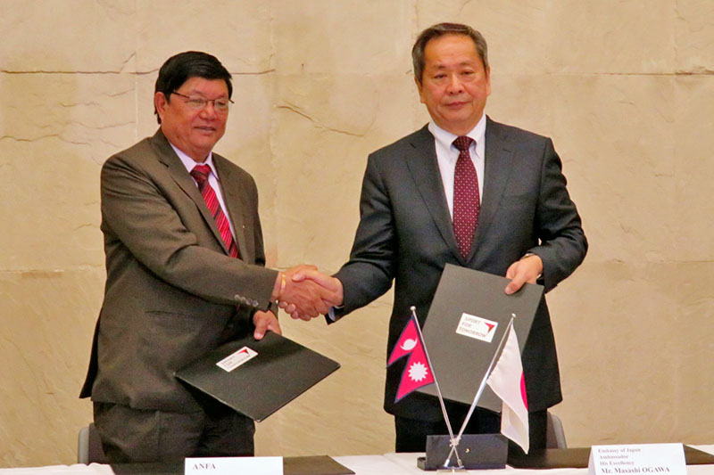 Dhirendra Kumar Pradhan, General Secretary of ANFA (left) and Masashi Ogawa, Ambassador of Japan to Nepal shake hands after signing an MoU in Kathmandu, on Wednesday, February 28, 2018. Photo courtesy: Japanese Embassy in Kathmandu