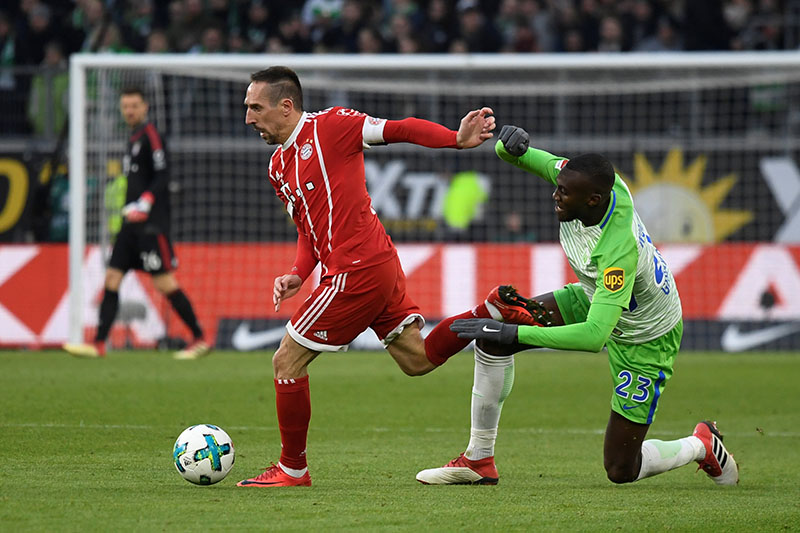 Bayern Munich's Franck Ribery in action with Wolfsburg's Josuha Guilavogui. Photo: Reuters