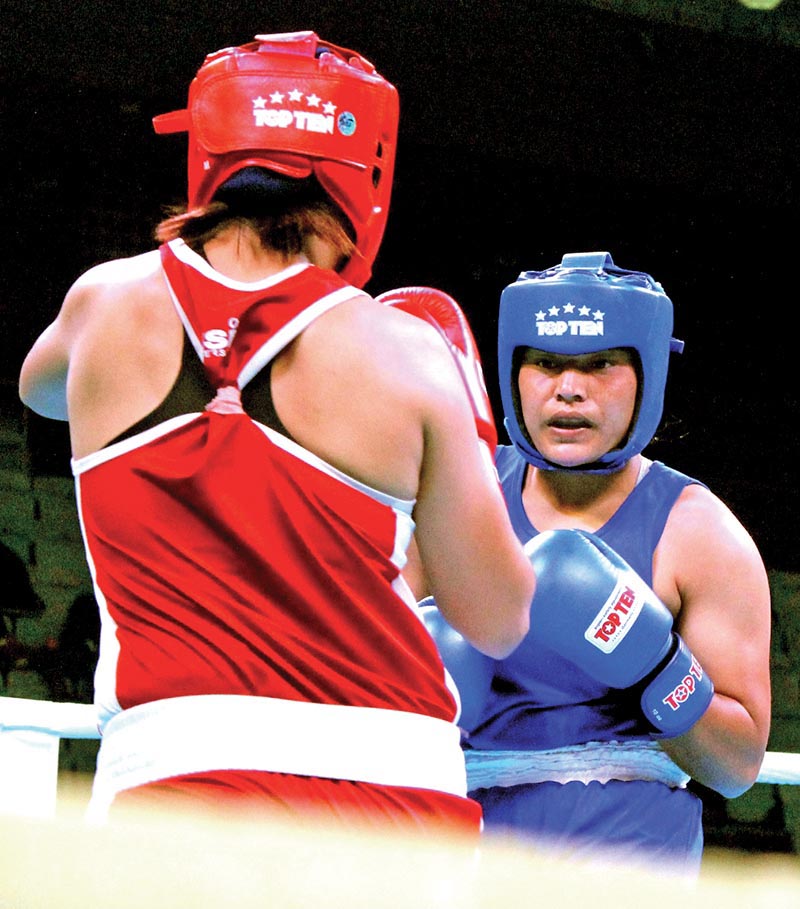 Nepalu2019s Punam Rawal fights against Indiau2019s Basumatary Pwilao (left) during their Indian Open International Boxing Tournament bout in New Delhi on Wednesday. Photo: NSJF